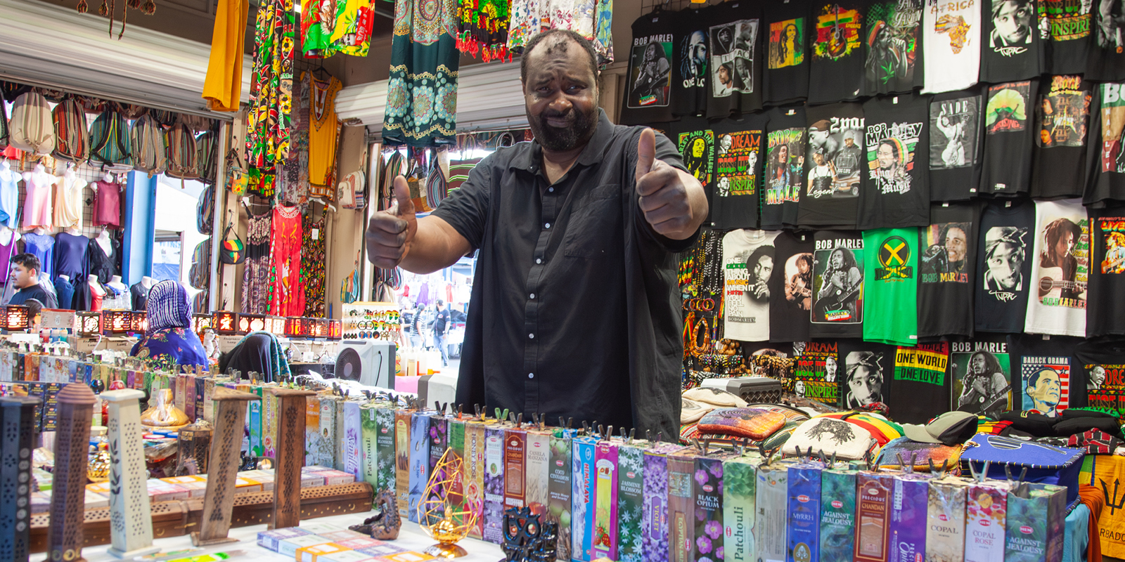 Vendor with Bob Marley Tees Giving Thumbs Up